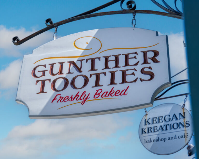 Guther Tooties Carved Wood Hanging Blade Sign by Zebra Visuals