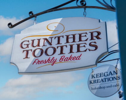 Guther Tooties Carved Wood Hanging Blade Sign by Zebra Visuals